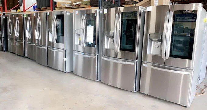 MG Appliance showroom — rows of French-door refrigerators